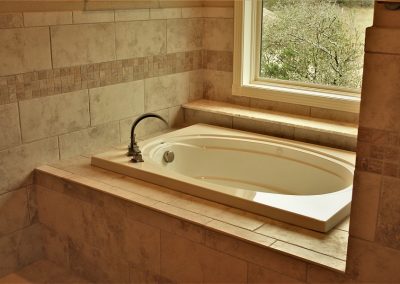 Square Garden Tub. White square garden tub with beige tile wall surround