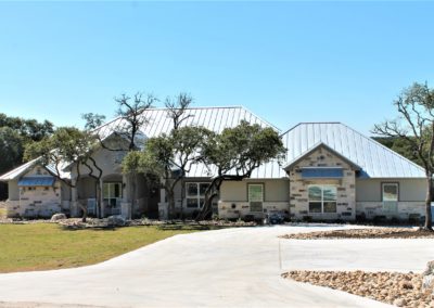 Texas Hill Country Home. Stucco and rock home with metal roof