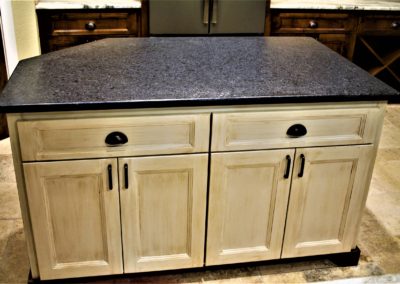 Kitchen island cabinet with antique finish and black granite countertop