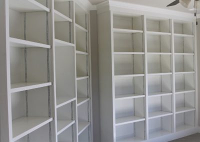 White custom built-in adjustable bookshelves.