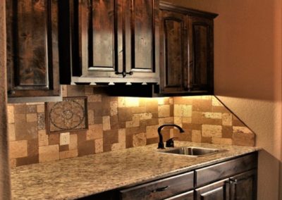Butler Pantry Cabinets with granite countertops and multi colored tile backsplash
