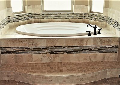 Custom Home Garden Tub. White garden tub with tiled walls and platform with step