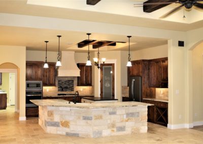 Custom Home Kitchen with dark alder cabinets in Vintage Oaks New Braunfels Texas