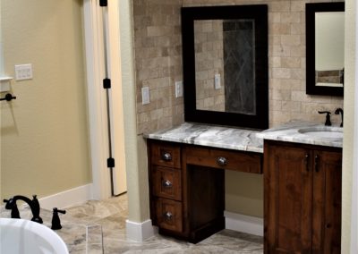 Custom Bathroom Vanity. Master vanity cabinets with knee space marble top framed mirrors and bronze wall mounted light fixtures