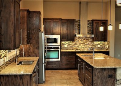 Dark Oak Kitchen Cabinets with over sized island cabinet with granite countertop