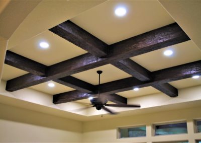 dark brown rustic faux wood beams installed in a coffered style in a tray ceiling