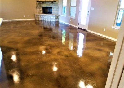 Brown stained concrete floor in great room of custom home