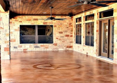 Stained Concrete Patio with Texas Star design etched into floor. Spring Branch, Texas custom home.