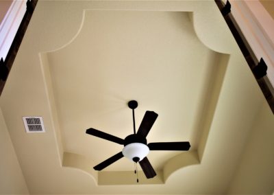 Tray ceiling with round corners and ceiling fan in home study