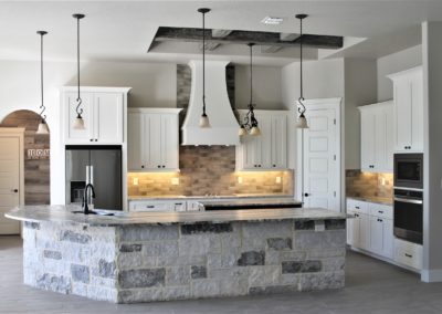 White Custom Cabinets. Garden Ridge Texas custom kitchen. White kitchen cabinets with grey rock bar wall