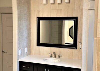 master bath vanity in alcove with tiled walls and tiled arch ceiling.