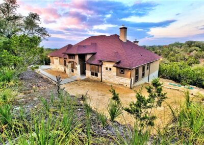 Texas Hill Country Custom Home. Rock and stucco exterior with shingle roof.